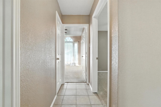 7436 Bennington Dr, Watauga, TX 76148 - hallway featuring a textured wall and light tile patterned flooring