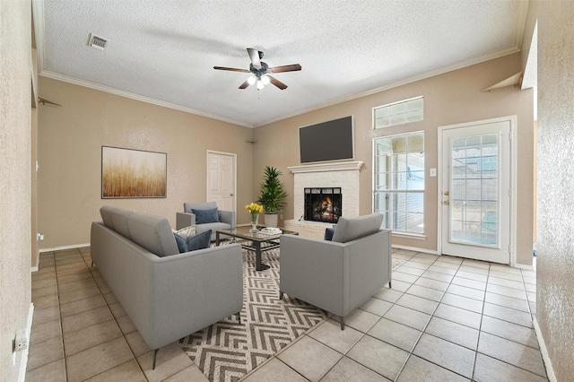 7436 Bennington Dr, Watauga, TX 76148 - living area with a ceiling fan, light tile patterned floors, ornamental molding, a fireplace, and a textured ceiling