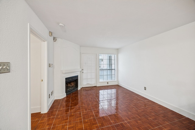 6108 Abrams Rd Unit 410, Dallas, TX 75231 - unfurnished living room with a fireplace and baseboards