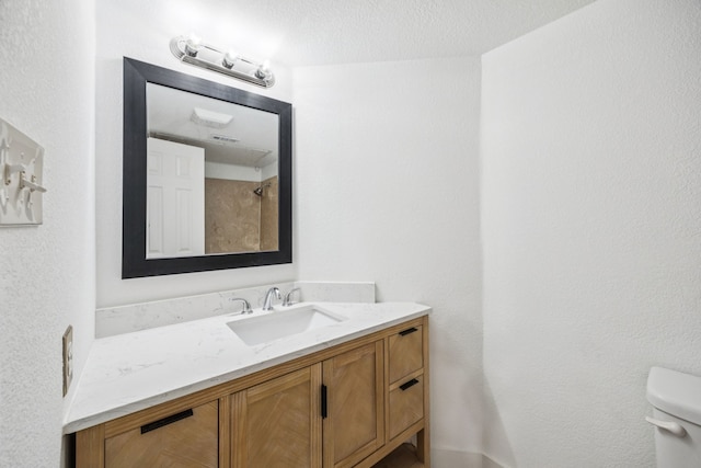 6108 Abrams Rd Unit 410, Dallas, TX 75231 - bathroom featuring vanity and toilet