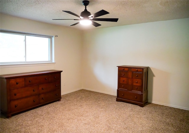 3501 Pecan Cir, Bedford, TX 76021 - unfurnished bedroom featuring carpet flooring, a textured ceiling, and a ceiling fan