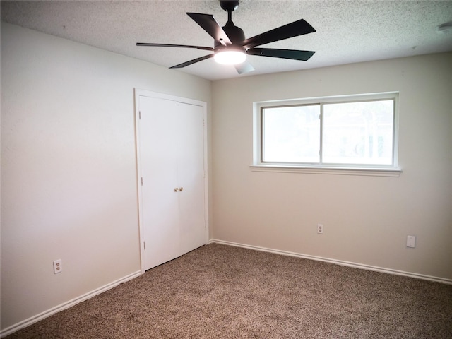 3501 Pecan Cir, Bedford, TX 76021 - unfurnished bedroom featuring carpet, a closet, a textured ceiling, and ceiling fan