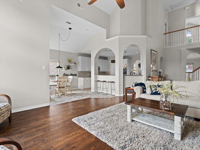 5503 Midnight Moon Dr, Frisco, TX 75036 - living area with ceiling fan, wood finished floors, high vaulted ceiling, and arched walkways
