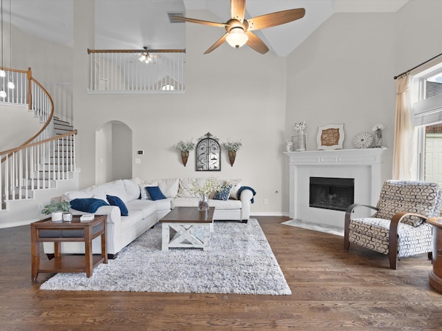 5503 Midnight Moon Dr, Frisco, TX 75036 - living area featuring high vaulted ceiling, stairs, wood finished floors, a ceiling fan, and arched walkways