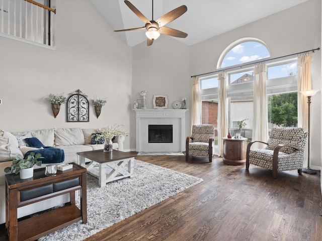 5503 Midnight Moon Dr, Frisco, TX 75036 - living area with high vaulted ceiling, a ceiling fan, a fireplace with flush hearth, and wood finished floors