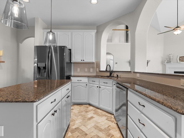 5503 Midnight Moon Dr, Frisco, TX 75036 - kitchen with stainless steel appliances, tasteful backsplash, white cabinets, a kitchen island, and a ceiling fan