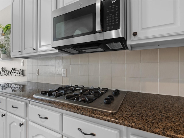 5503 Midnight Moon Dr, Frisco, TX 75036 - kitchen with appliances with stainless steel finishes, white cabinetry, backsplash, and dark stone counters