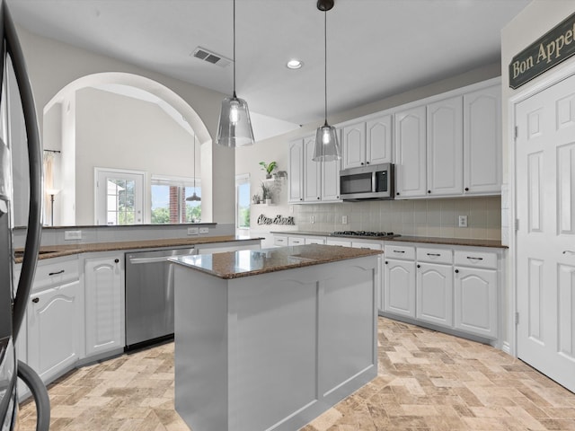 5503 Midnight Moon Dr, Frisco, TX 75036 - kitchen with appliances with stainless steel finishes, a center island, white cabinets, decorative backsplash, and recessed lighting