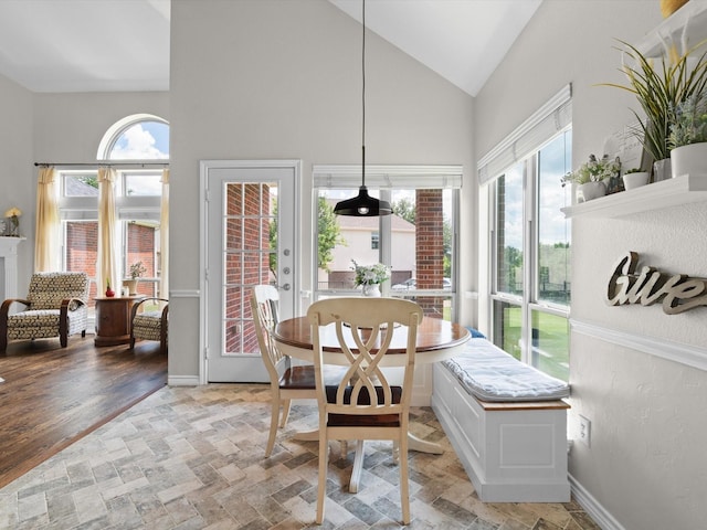 5503 Midnight Moon Dr, Frisco, TX 75036 - dining space featuring high vaulted ceiling and light stone finish floors