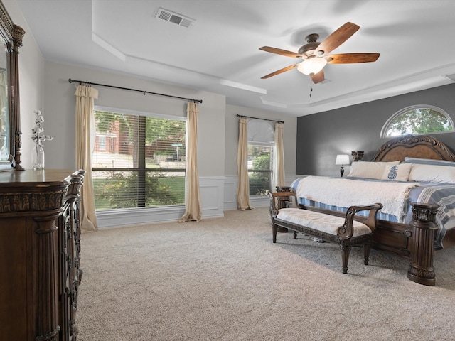5503 Midnight Moon Dr, Frisco, TX 75036 - bedroom with carpet floors, a raised ceiling, wainscoting, and ceiling fan