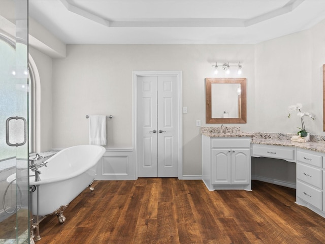 5503 Midnight Moon Dr, Frisco, TX 75036 - full bath with vanity, wood finished floors, a freestanding tub, a stall shower, and a tray ceiling