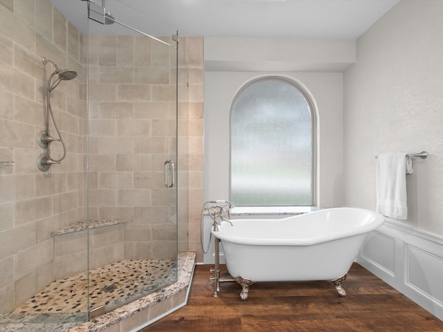 5503 Midnight Moon Dr, Frisco, TX 75036 - bathroom with a shower stall, wood finished floors, a soaking tub, and wainscoting