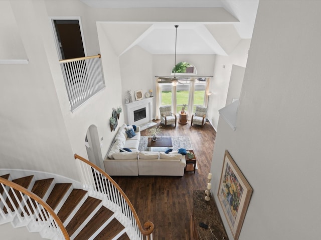 5503 Midnight Moon Dr, Frisco, TX 75036 - living room featuring a high ceiling, a ceiling fan, wood finished floors, a fireplace, and stairs