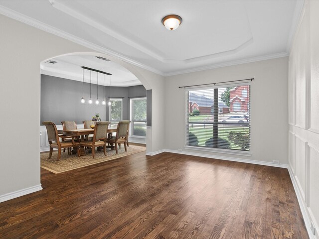 5503 Midnight Moon Dr, Frisco, TX 75036 - dining area featuring arched walkways, dark wood finished floors, a raised ceiling, and ornamental molding