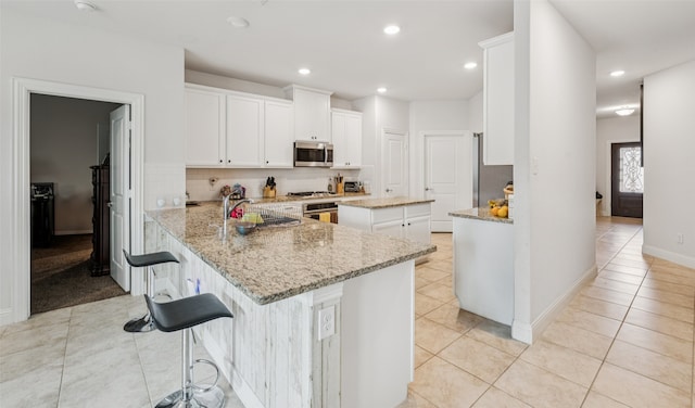 3814 Bastrop St, Melissa, TX 75454 - kitchen with stainless steel microwave, light tile patterned floors, light stone countertops, decorative backsplash, and recessed lighting