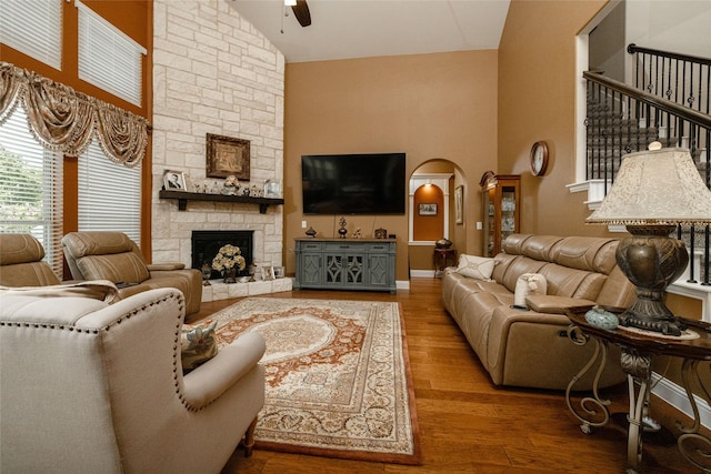 2604 Gavin Dr, Mansfield, TX 76063 - living area featuring high vaulted ceiling, ceiling fan, wood finished floors, a stone fireplace, and arched walkways