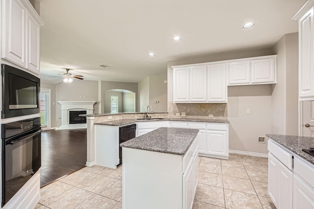 1119 Leafy Glade Rd, Forney, TX 75126 - kitchen featuring black appliances, ceiling fan, white cabinetry, a peninsula, and dark stone countertops