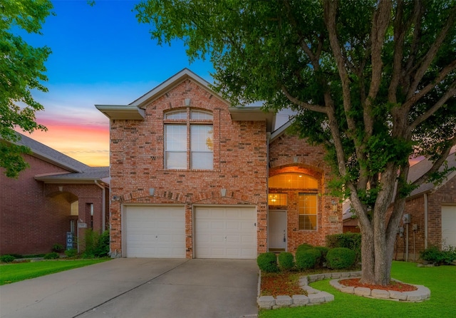 511 Poplar Ln, Irving, TX 75063 - traditional home with concrete driveway, an attached garage, brick siding, and a front yard
