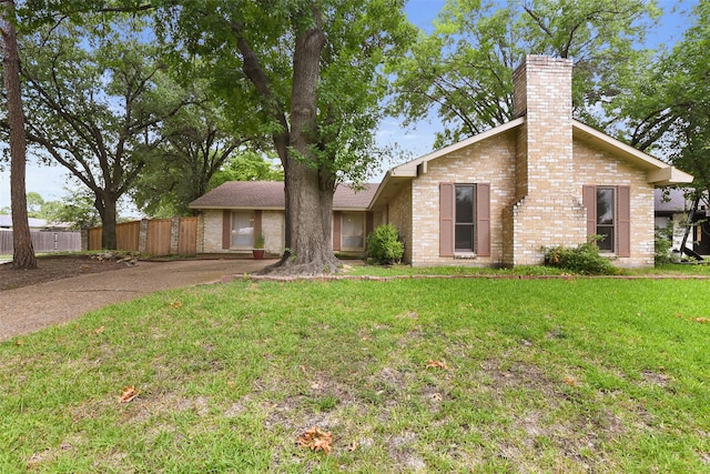 921 Sleepy Hollow Dr, Garland, TX 75043 - mid-century home featuring a chimney, brick siding, and driveway