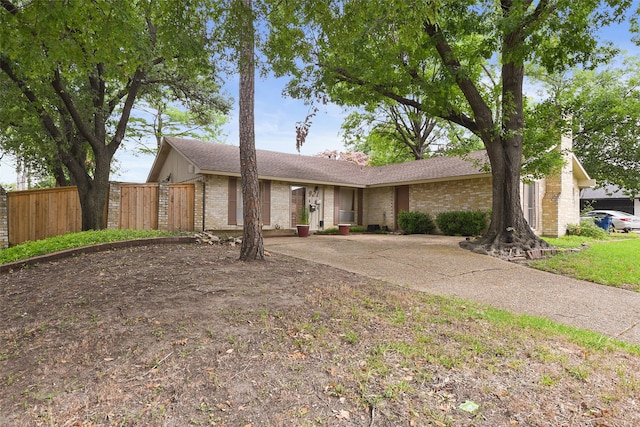 921 Sleepy Hollow Dr, Garland, TX 75043 - mid-century home featuring concrete driveway, brick siding, and roof with shingles