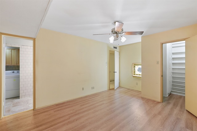 921 Sleepy Hollow Dr, Garland, TX 75043 - unfurnished bedroom with washer / clothes dryer, wood finished floors, connected bathroom, ceiling fan, and a walk in closet