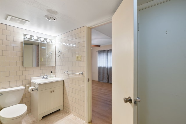 921 Sleepy Hollow Dr, Garland, TX 75043 - bathroom featuring tile walls and vanity