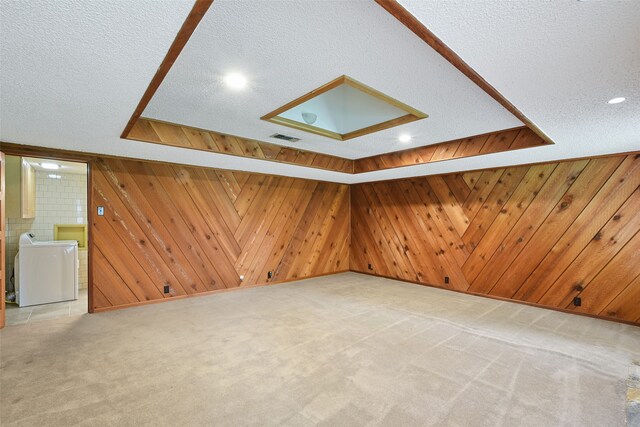 921 Sleepy Hollow Dr, Garland, TX 75043 - additional living space featuring washer / dryer, a textured ceiling, light carpet, wooden walls, and recessed lighting