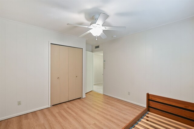 921 Sleepy Hollow Dr, Garland, TX 75043 - unfurnished bedroom with wood finished floors, ceiling fan, and a closet