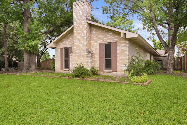 921 Sleepy Hollow Dr, Garland, TX 75043 - back of property featuring brick siding and a chimney