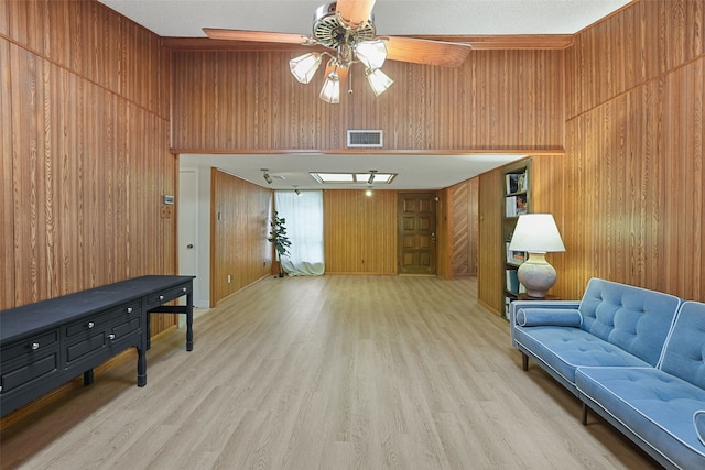 921 Sleepy Hollow Dr, Garland, TX 75043 - living room with wooden walls, light wood-type flooring, and a ceiling fan