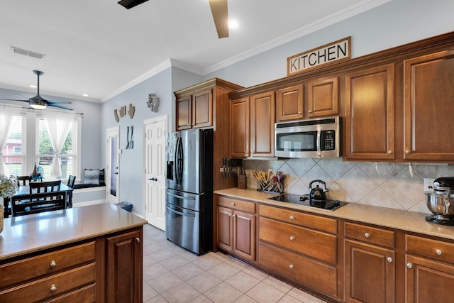 7251 Misty Glen Ln, Midlothian, TX 76065 - kitchen featuring appliances with stainless steel finishes, a ceiling fan, decorative backsplash, light tile patterned floors, and brown cabinetry