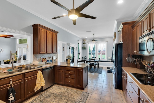 7251 Misty Glen Ln, Midlothian, TX 76065 - kitchen featuring a ceiling fan, stainless steel appliances, a peninsula, backsplash, and light tile patterned flooring