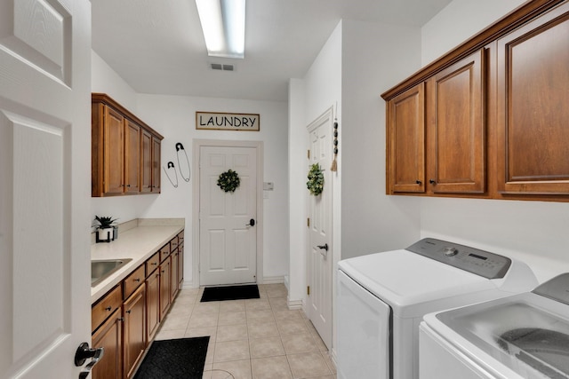 7251 Misty Glen Ln, Midlothian, TX 76065 - laundry area featuring cabinet space, washer and clothes dryer, and light tile patterned floors