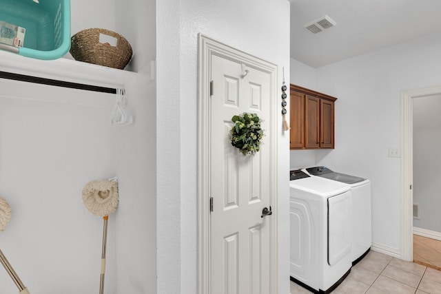 7251 Misty Glen Ln, Midlothian, TX 76065 - laundry room featuring separate washer and dryer, cabinet space, and light tile patterned flooring