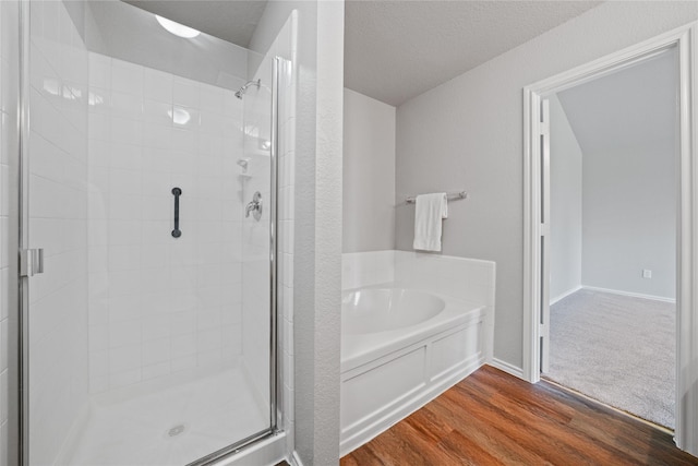 1617 Brookstone Dr, Little Elm, TX 75068 - bathroom featuring a stall shower, a bath, and wood finished floors