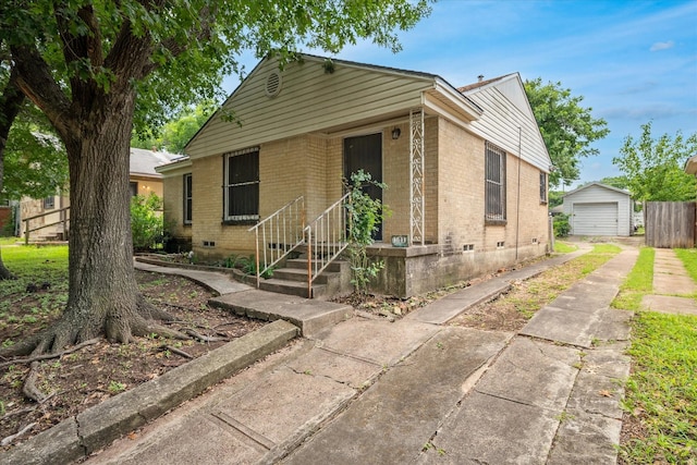 1611 Glen Ave, Dallas, TX 75216 - bungalow-style house featuring concrete driveway, brick siding, a garage, crawl space, and an outdoor structure
