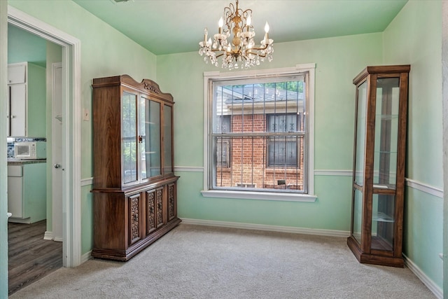 1611 Glen Ave, Dallas, TX 75216 - carpeted empty room featuring a chandelier and baseboards