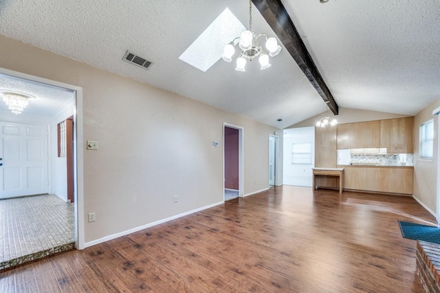 6221 Onyx Dr N, North Richland Hills, TX 76180 - unfurnished living room with a chandelier, wood finished floors, a textured ceiling, and a skylight