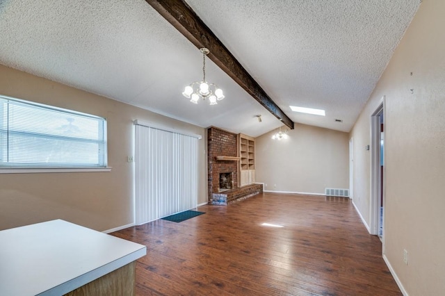 6221 Onyx Dr N, North Richland Hills, TX 76180 - unfurnished living room featuring a textured ceiling, dark wood-style floors, a chandelier, a brick fireplace, and built in features