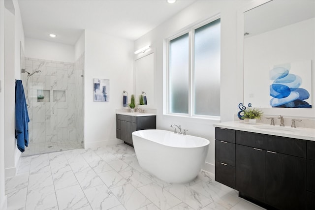 8305 Caballo Dr, North Richland Hills, TX 76182 - bathroom featuring a shower stall, marble look tiles, a freestanding bath, two vanities, and recessed lighting