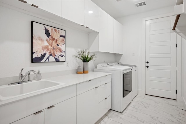 8305 Caballo Dr, North Richland Hills, TX 76182 - washroom with cabinet space, washing machine and clothes dryer, and light marble finish floors