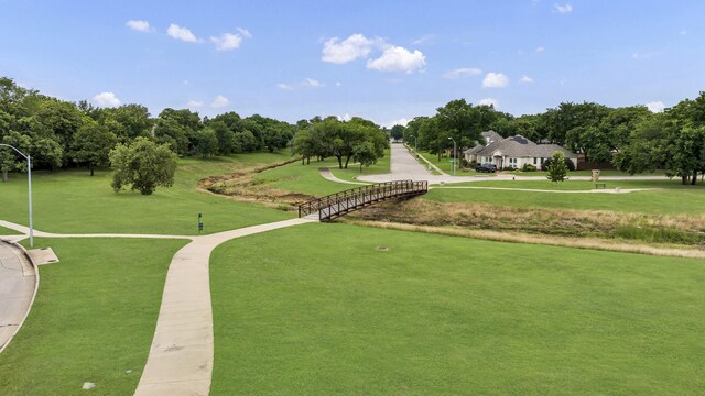 8305 Caballo Dr, North Richland Hills, TX 76182 - view of home's community with a lawn and view of wooded area
