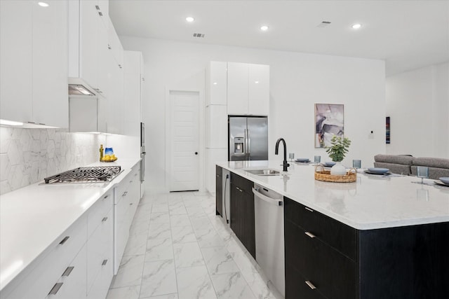 8305 Caballo Dr, North Richland Hills, TX 76182 - kitchen featuring appliances with stainless steel finishes, modern cabinets, dark cabinets, white cabinets, and light marble finish floors