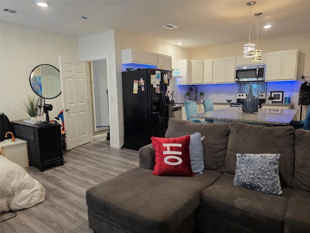 1037 Cavender Dr, Hurst, TX 76053 - living room with light wood-style floors and recessed lighting