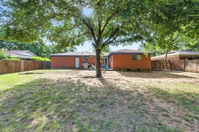 1037 Cavender Dr, Hurst, TX 76053 - rear view of property with a fenced backyard and brick siding