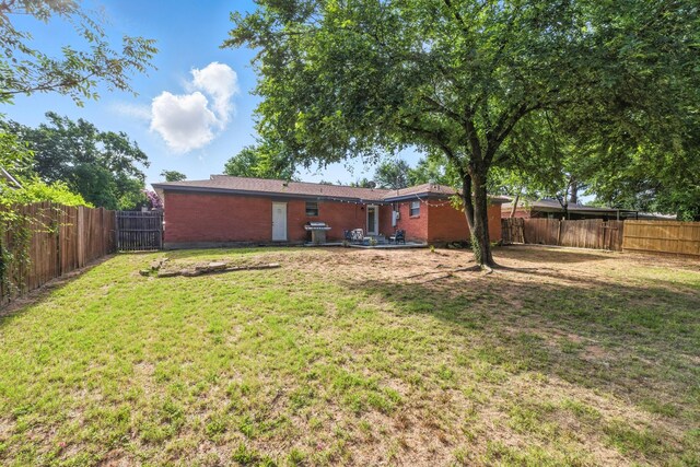 1037 Cavender Dr, Hurst, TX 76053 - back of house with brick siding and a fenced backyard