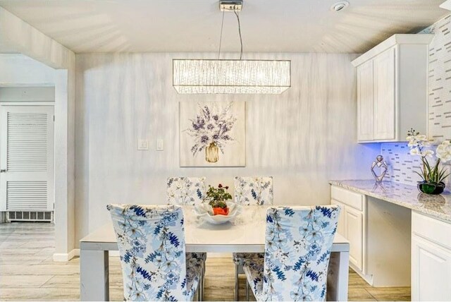 1037 Cavender Dr, Hurst, TX 76053 - dining area featuring a chandelier, light wood finished floors, and breakfast area