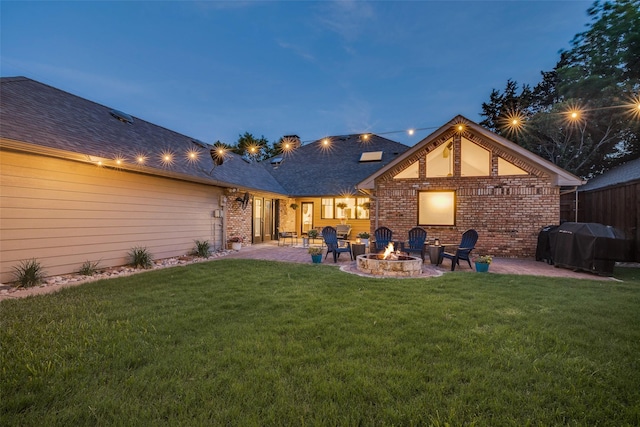 1509 Banbury Ct, Richardson, TX 75082 - back of property with an outdoor fire pit, a patio area, brick siding, and a lawn