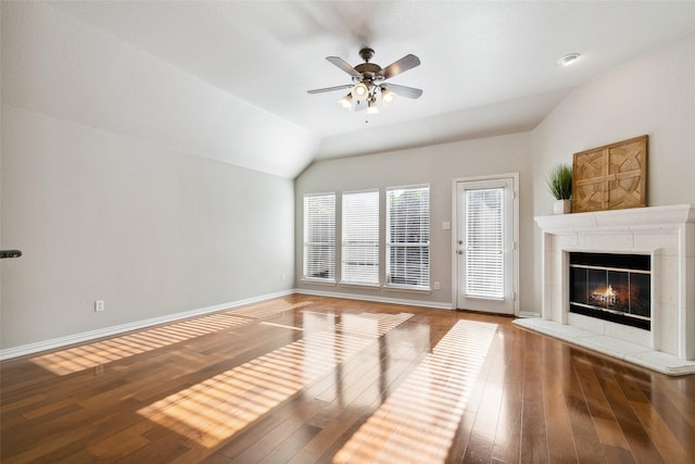 8648 Marion Dr, Frisco, TX 75036 - unfurnished living room featuring lofted ceiling, ceiling fan, wood-type flooring, and a tile fireplace