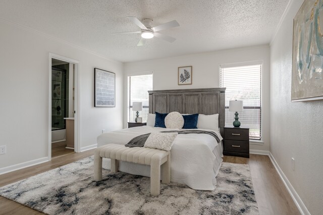 2508 Independence Dr, Mesquite, TX 75150 - bedroom featuring light wood-style flooring, a textured ceiling, ornamental molding, ensuite bath, and ceiling fan